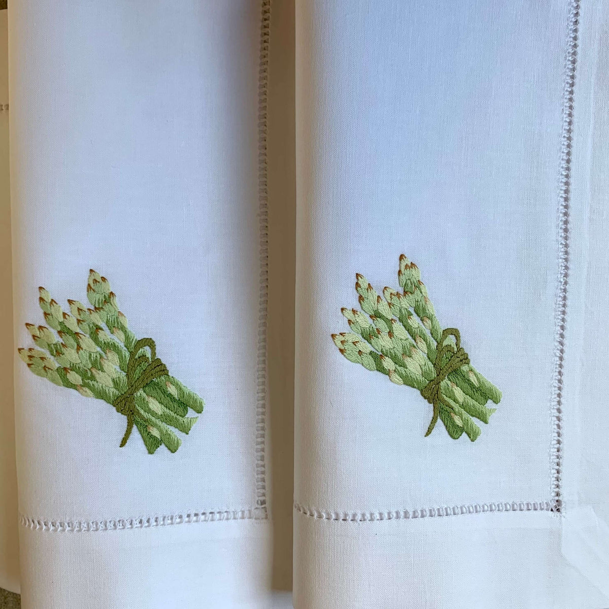 Weiße Stoffservietten mit Spargel bestickt und 4cm Bordüre mit Handhohlsaum.